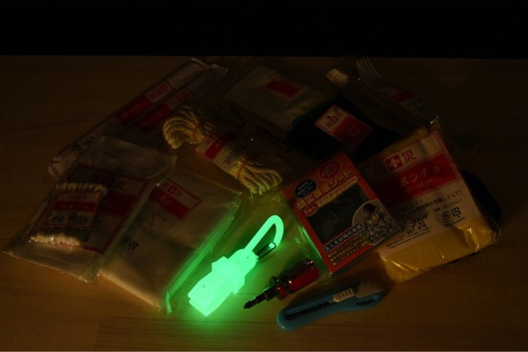 A glowing carabiner on an emergency kit during a blackout