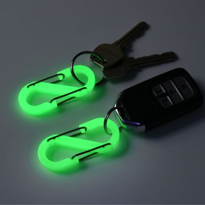 Two glowing OBORO S-shaped carabiners on a car key